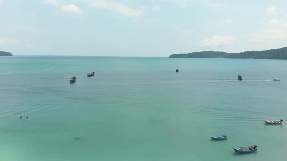 Panoramic view of encircling bay populated by fishing boats moored above the turquoise sea, Cambodia