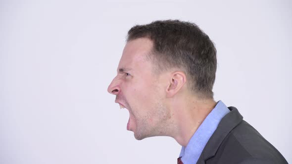 Head Shot Profile View of Angry Businessman Shouting