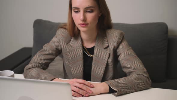 Portrait of Tired Young Woman Working on Laptop at the Home Office