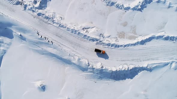 Aerial View of Truck Driving on Snowy Road at Area of Oil Refinery Outdoors