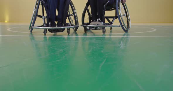 Two Friends with Disabilities in Wheelchairs Waiting for the Start of the Match in a Modern Hall