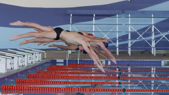 Swimmers diving into the pool