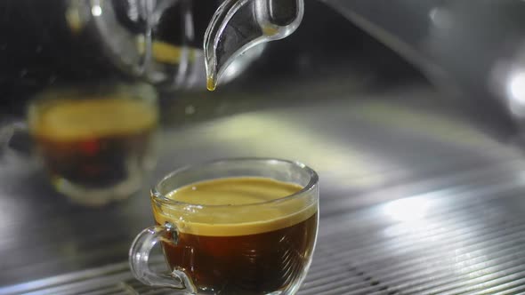 Making Espresso Coffee in a Coffee Machine and Pouring to Cup