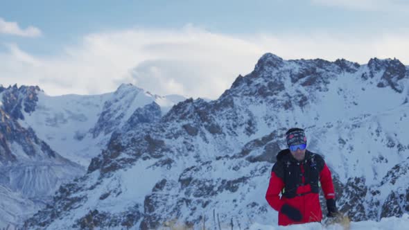 Man Running at the Mountain with Snow