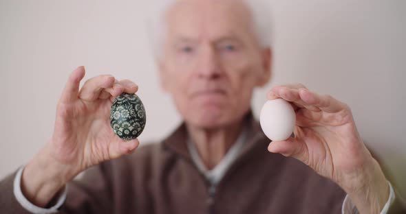 Senior Man Holding Easter Eggs in Hands