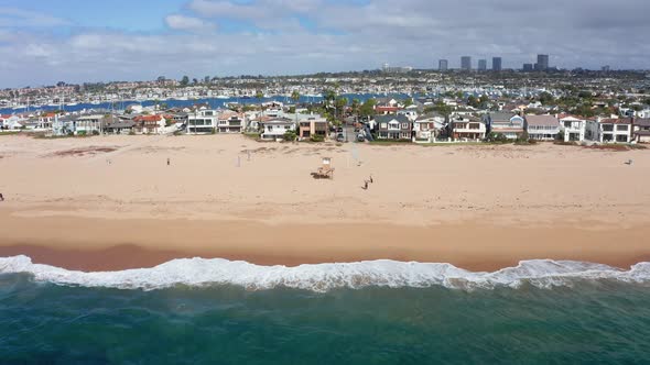 Newport beach shoreline, California. Beachfront condominium and villas, aerial zooming out