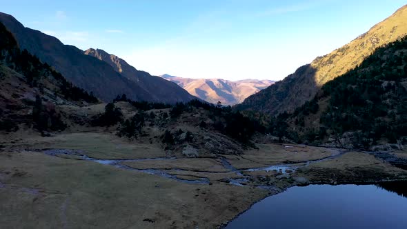 Val d'Arrouge creek at Lac d'Espingo mountain lake in Haute-Garonne, Pyrénées, France, Aerial flyove