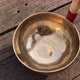 A Man Plays a Bat on a Copper Tibetan Singing Bowl - VideoHive Item for Sale