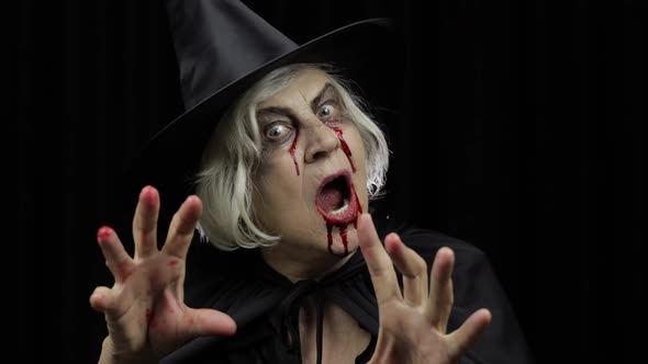 Old Witch Halloween Makeup. Elderly Woman Portrait with Blood on Her Face