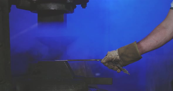 Blacksmith Long Iron Stick By Hands Under Press Holding