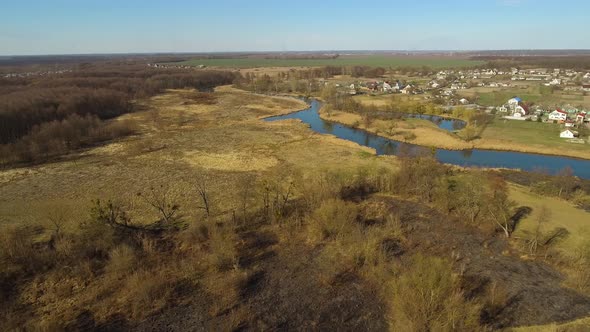 Aerial View of Calm Rural Countryside with River and Fields Around. Top View of Beautiful Ukrainian