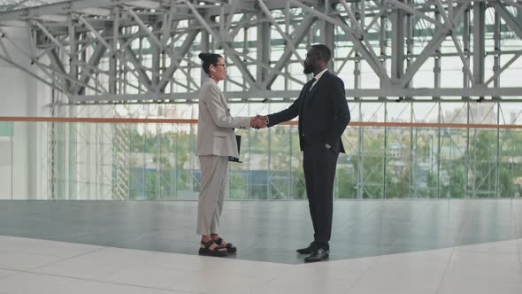 Businesspeople Shaking Hands in Office Building