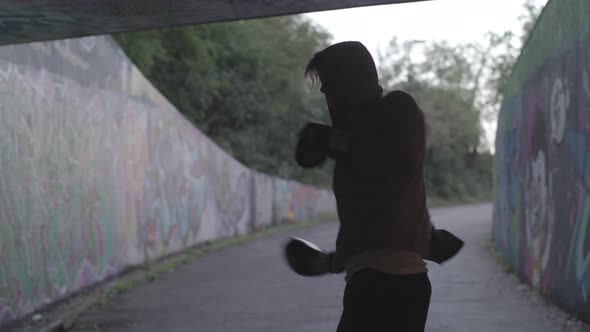 Wide Shot of Young Attract Man Boxing In Underpass, In Slow Motion.