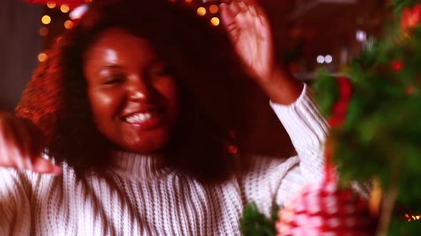 Spanish Happy Woman in White Sweater and Deer Horn Dancing and Singing in Living Room Alone