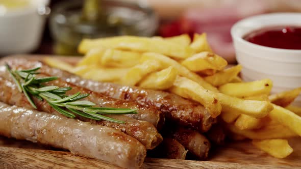 Bowl with Sauce and Smoked Sausages with Fried Potatoes Rotating Closeup