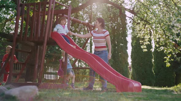 Mom Plays with Daughter in the Park