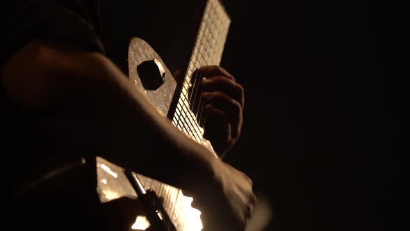 Male Guitarist Plays the Guitar in the Dark. Kyiv. Ukraine