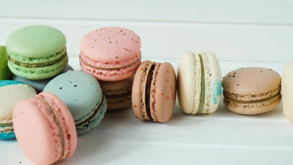 Macaroons or Macarons Lie on a White Wooden Background, a Row of Almond Cookies
