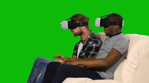 Men in VR Glasses Sitting on the Couch. Green Screen