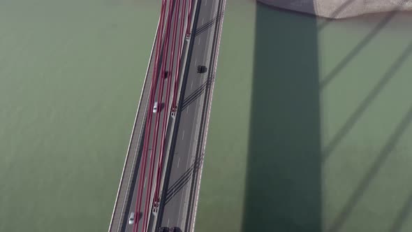 Vehicles Crossing a Cable Stayed Suspension Bridge Crossing a River