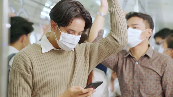 Traveler Wearing Face Mask While Using Mobile Phone on Public Train