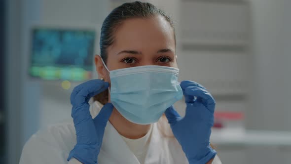 Portrait of Biologist Taking Off Face Mask in Laboratory