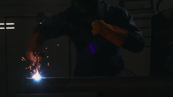 Metal Welder Working with Arc Welding Machine