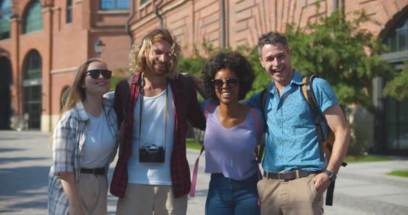 Medium Shot of Diverse Students Smiling at Camera and Having Fun Traveling Together