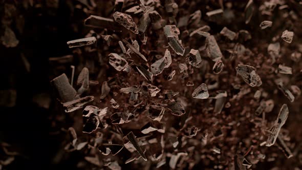 Super Slow Motion Shot of Raw Chocolate Chunks and Cocoa Powder After Being Exploded at 1000Fps.