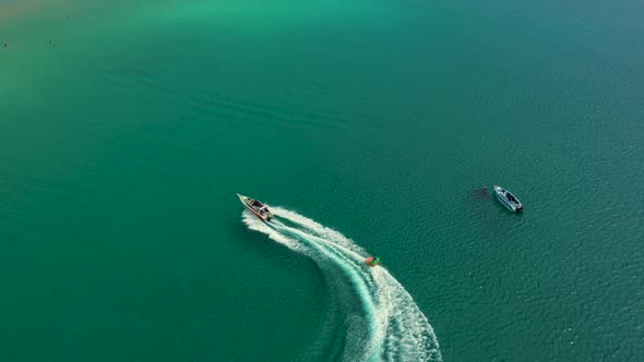 Aerial drone photo of extreme powerboat donut water-sports cruising in high speed in tropical turquo