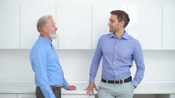 Handsome Young Man Talking with Presumed Elderly Father Before Genetic Paternity Test at Medical