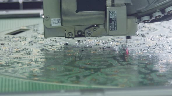 Close up of SMT Machine placing components on a circuit board