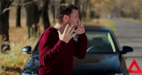 Sad Man Standing Near Her Broken Down Car