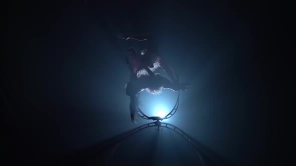 Rotate in the Air Two Gymnasts . Black Smoke Background. Silhouette. Slow Motion