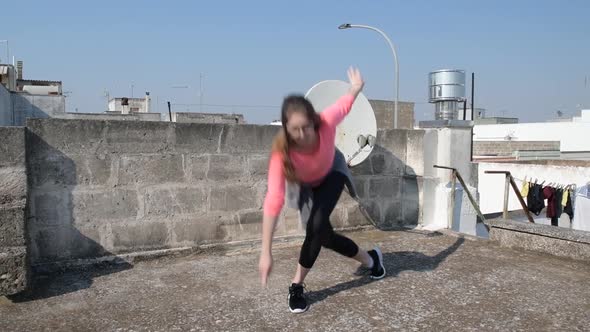 Young girl is doing lateral lunge inside on the roof