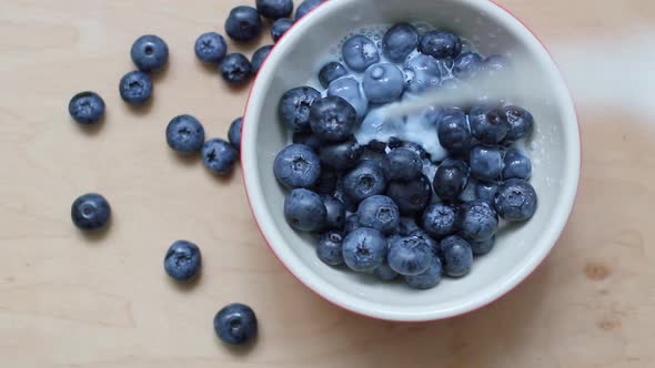 Pouring Milk Onto Blueberries in Motion