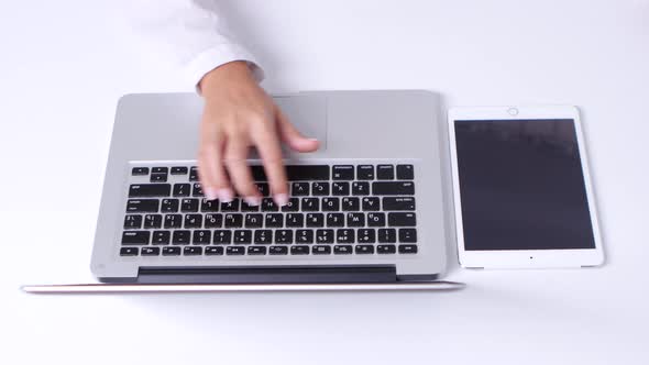 Girl Makes a Online Shopping Using Notebook and Laptop in the Office. Different Credit Cards. Close