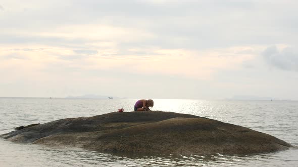 a Child on a Small Island in the Sea