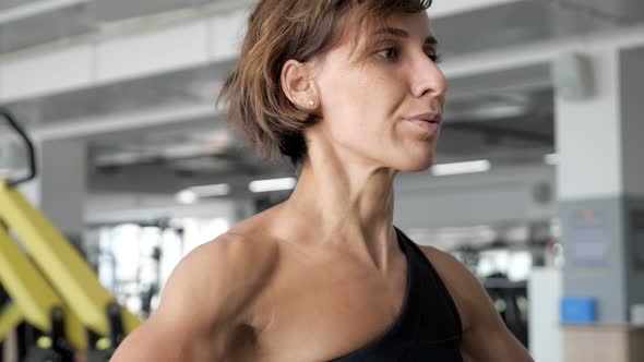 Woman is Lifting Barbell Making Exercises for Shoulders