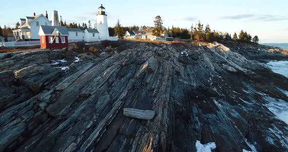 A man walking by the rocks in Curtis island lighthouse Camden Maine USA