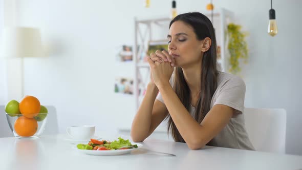 Young Woman Praying, Blessing God for Dinner, Eating Healthy Vegetarian Salad