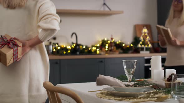 Woman sharing Christmas present with her sister. Shot with RED helium camera in 8K