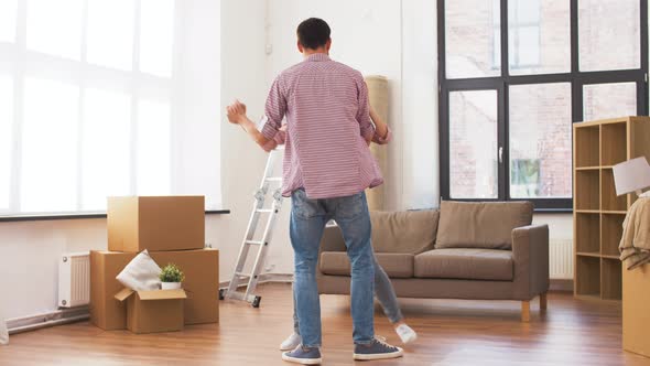 Happy Couple Moving To New Home and Dancing