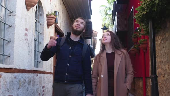 Couple of travelers are impressed by the ancient architecture.