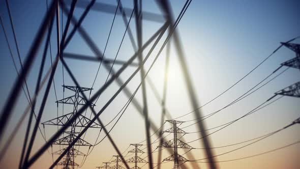 Endless electric powerlines and pylons loopable animation on a cloudless sky. HD