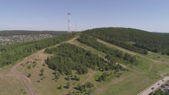 Aerial view of low mountain next to a pond in a provincial town. 10