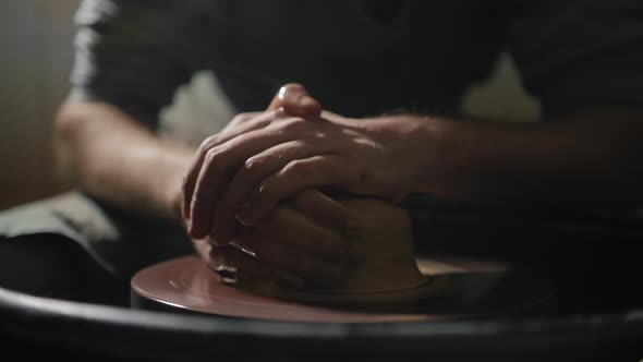 Artisan Hands Shaping Clay on a Potter's Wheel in Slow Motion