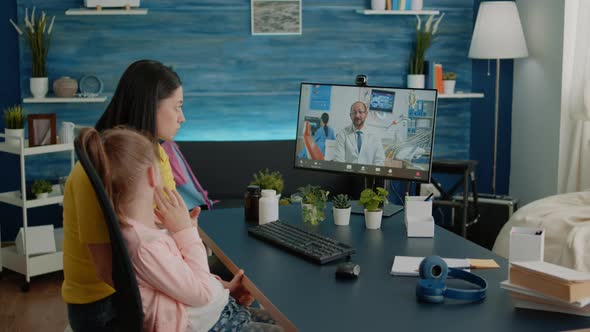 Worried Parent Talking to Dentist on Video Call About Child