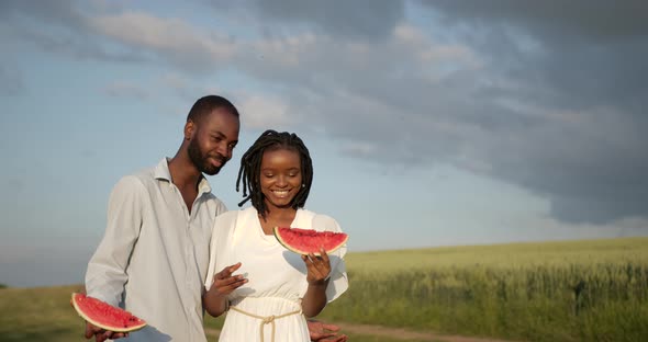 Black Couple with Watermelon on a Meadow