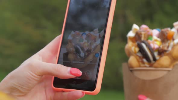 Woman Takes Photo of Traditional Korean Wafer with Phone